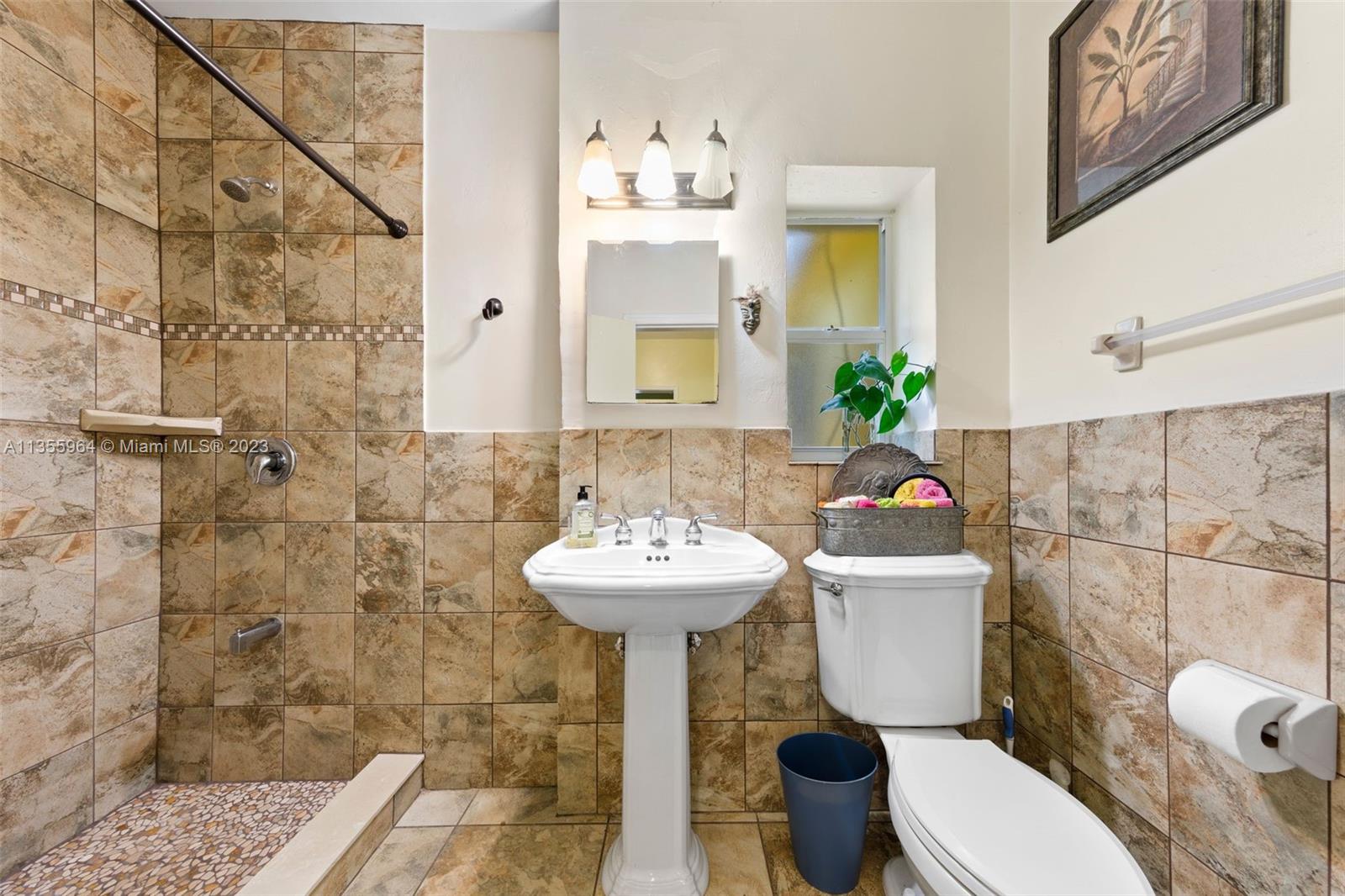 Redlands Homestead, FL 33031 - Photo 14 of 31 a bathroom with a sink mirror toilet and shower