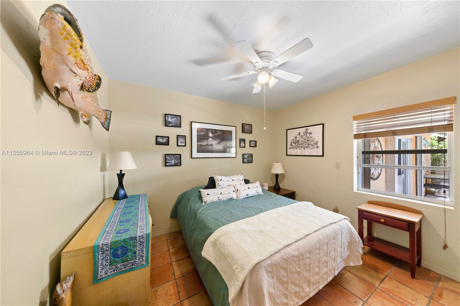 Redlands Homestead, FL 33031 - Photo 15 of 31 a bedroom with a bed and a chandelier