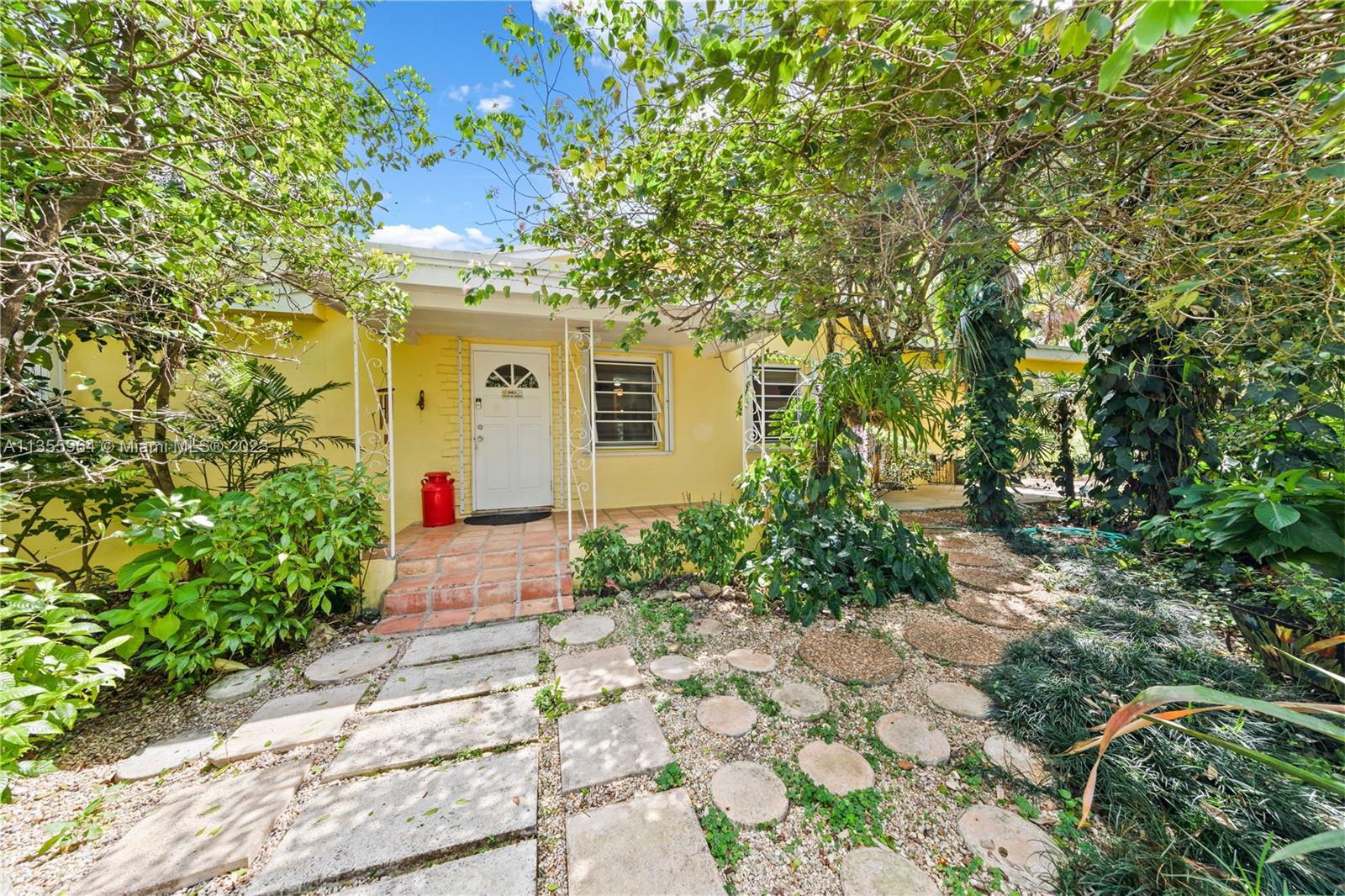 Redlands Homestead, FL 33031 - Photo 2 of 31 a front view of a house with a yard and potted plants
