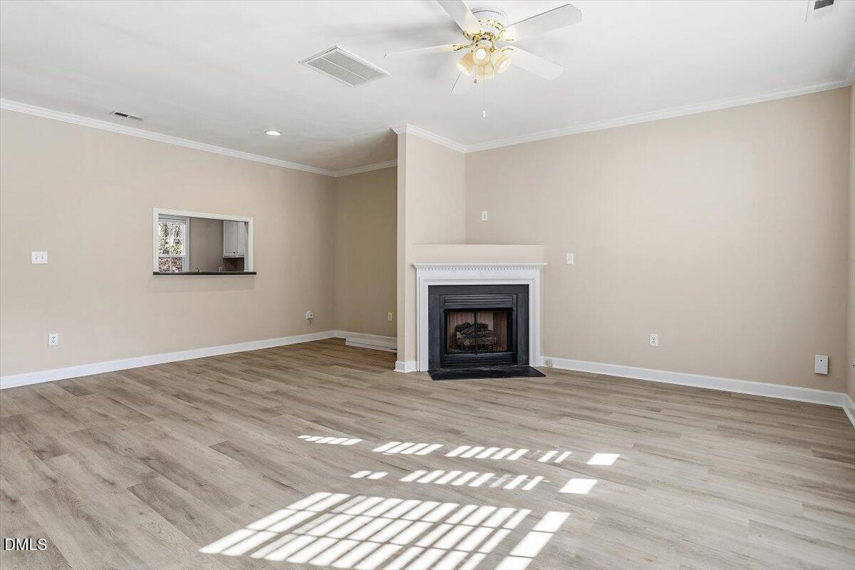 2220 Trailwood Valley Circle Raleigh, NC 27603 - Photo 11 of 37 a view of empty room with wooden floor and fan
