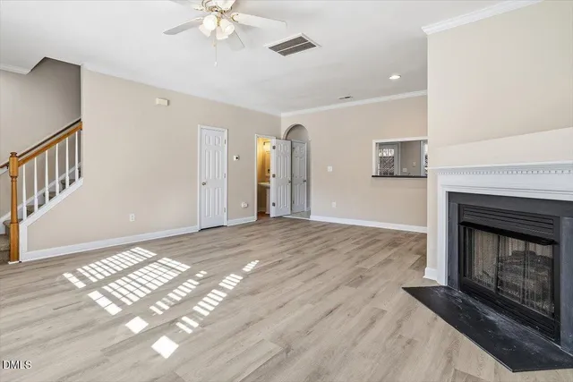 a view of an empty room with a fireplace and a window