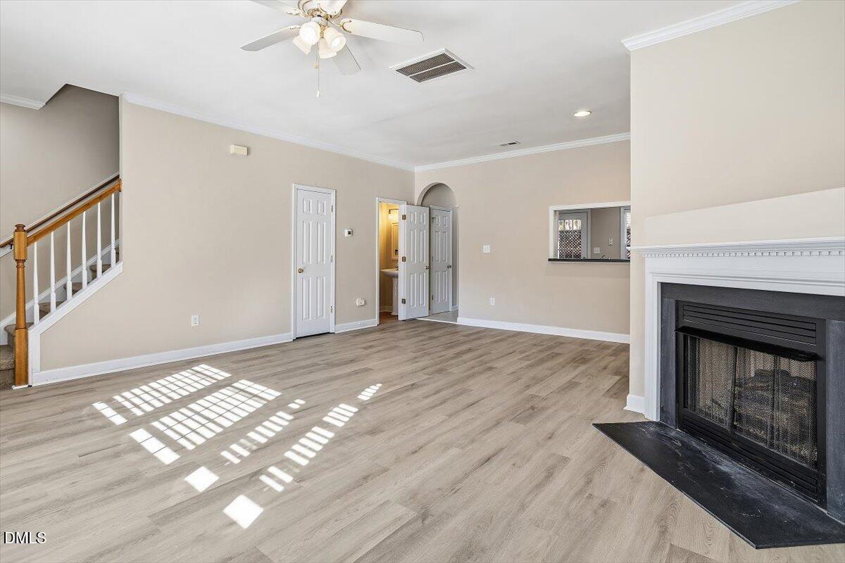 2220 Trailwood Valley Circle Raleigh, NC 27603 - Photo 14 of 37 a view of an empty room with a fireplace and a window
