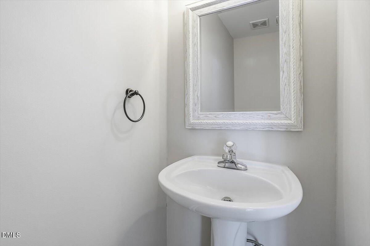 2220 Trailwood Valley Circle Raleigh, NC 27603 - Photo 17 of 37 a sink with a mirror