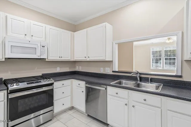 a kitchen with appliances a sink and lots of cabinets