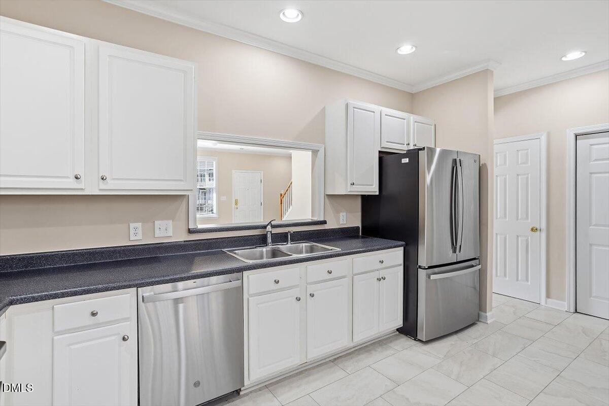 2220 Trailwood Valley Circle Raleigh, NC 27603 - Photo 24 of 37 a kitchen with appliances a sink and lots of cabinets