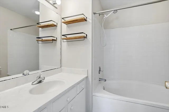 a bathroom with a bath tub with a shower