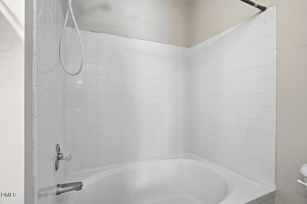 2220 Trailwood Valley Circle Raleigh, NC 27603 - Photo 34 of 37 a bathroom with a bath tub with a shower