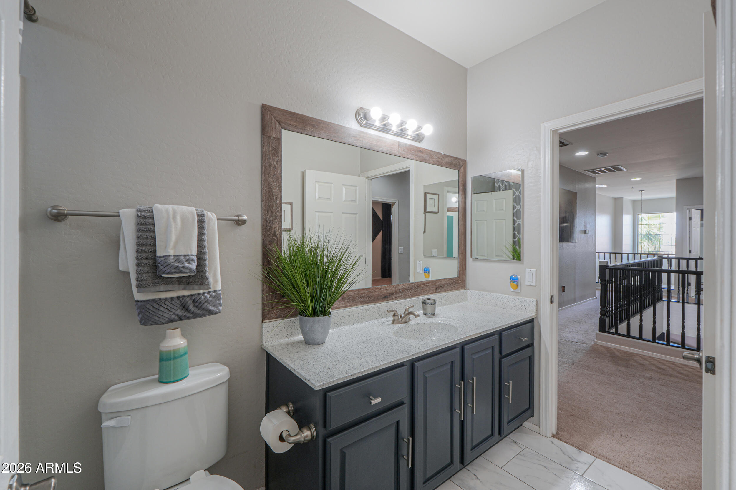 45247 West Jack Rabbit Trail Maricopa, AZ 85139 - Photo 38 of 75 a bathroom with a sink a toilet and a mirror