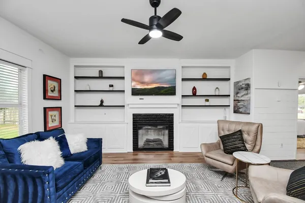 a living room with furniture and a fireplace