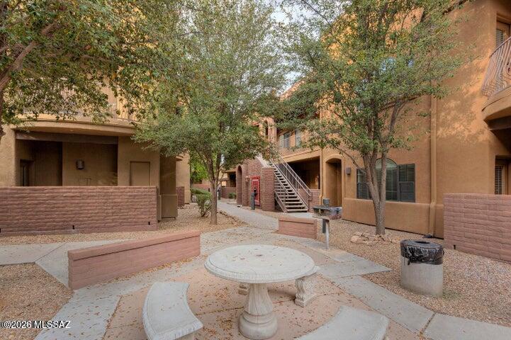2018 East River Road, Unit 102 Tucson, AZ 85718 - Photo 2 of 25 a front view of a house with a yard