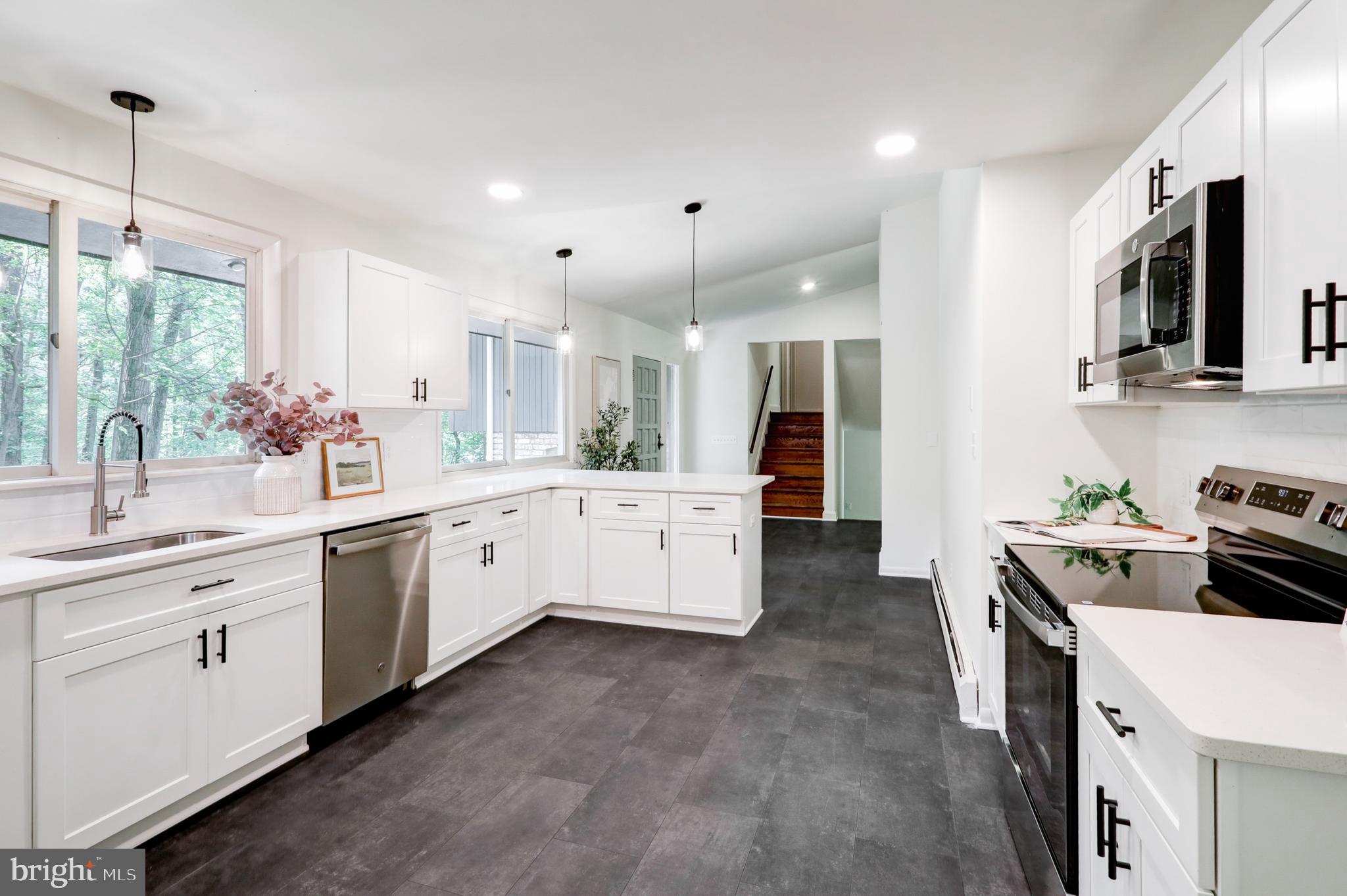 1254 Pinch Valley Road Westminster, MD 21158 - Photo 15 of 45 a kitchen with a sink stove and cabinets