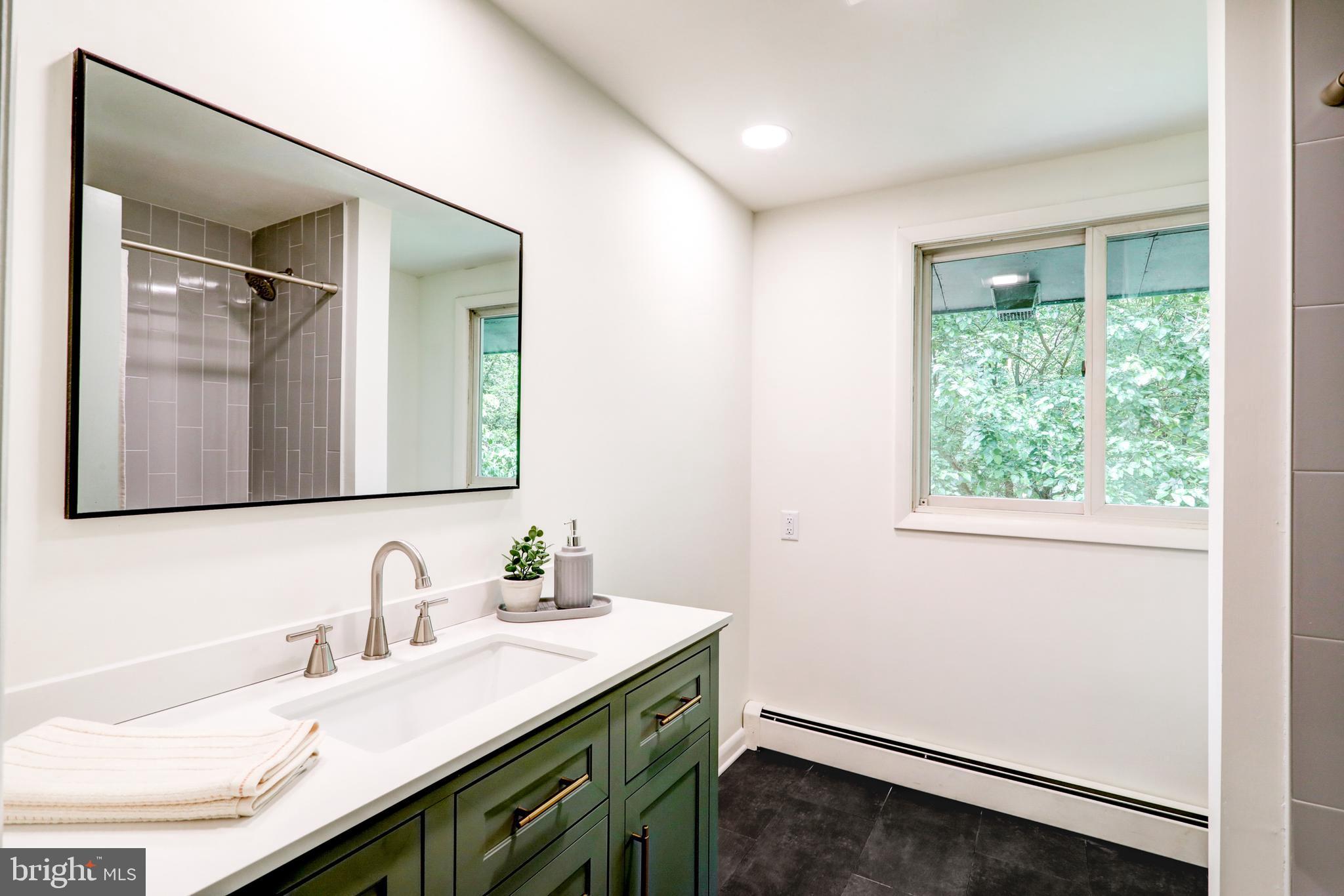 1254 Pinch Valley Road Westminster, MD 21158 - Photo 28 of 45 a bathroom with a granite countertop sink a mirror and a window