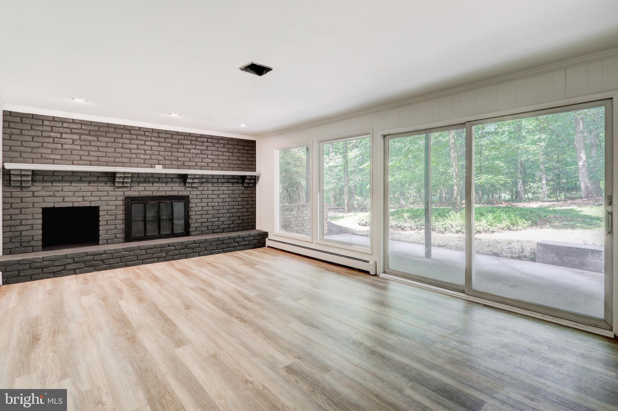 1254 Pinch Valley Road Westminster, MD 21158 - Photo 37 of 45 a view of empty room with wooden floor and fireplace