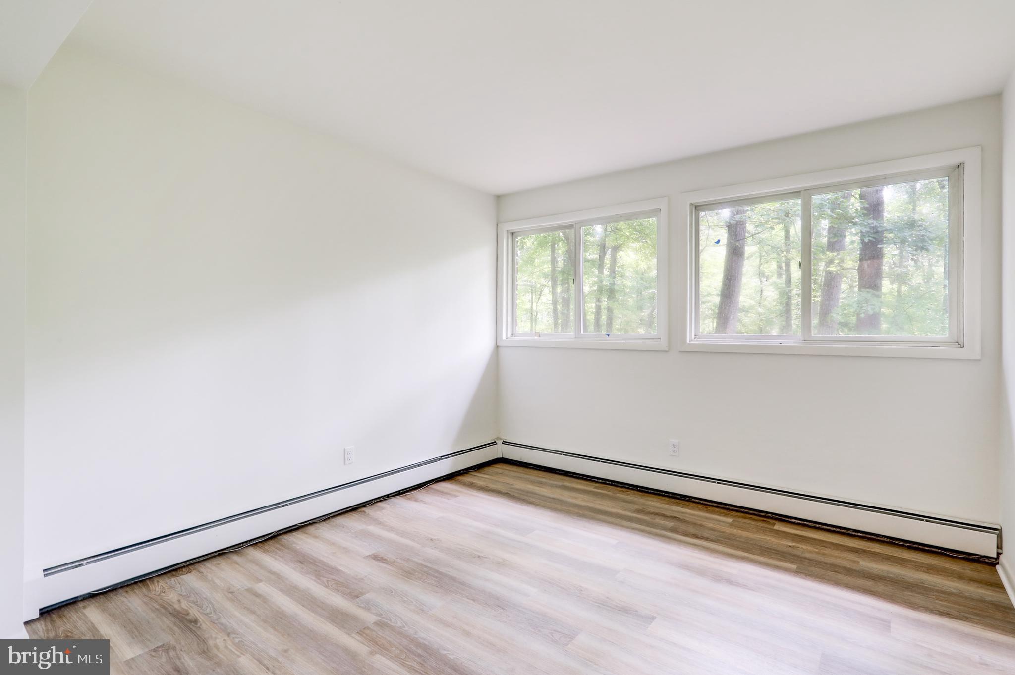 1254 Pinch Valley Road Westminster, MD 21158 - Photo 41 of 45 an empty room with wooden floor and windows