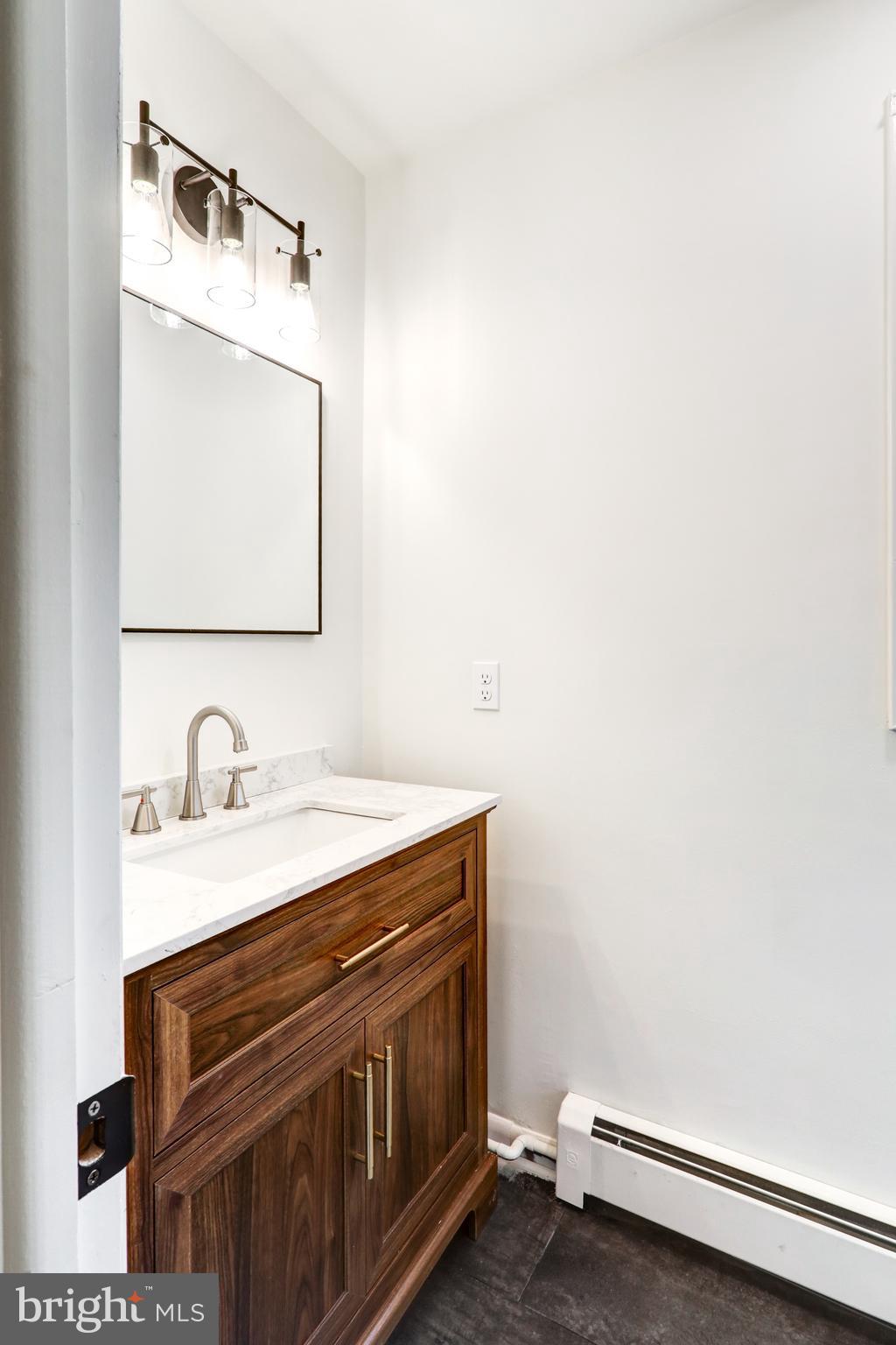 1254 Pinch Valley Road Westminster, MD 21158 - Photo 44 of 45 a bathroom with a sink and a mirror