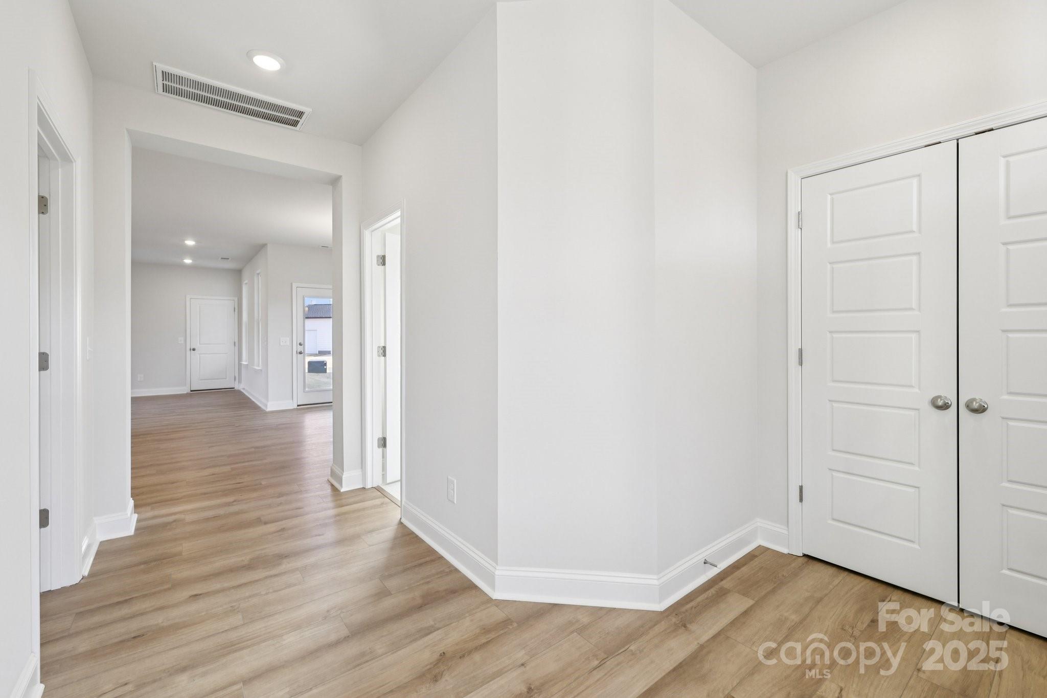 9612 Pointer Road, Unit 59 Huntersville, NC 28078 - Photo 19 of 43 a view of a hallway with wooden floor