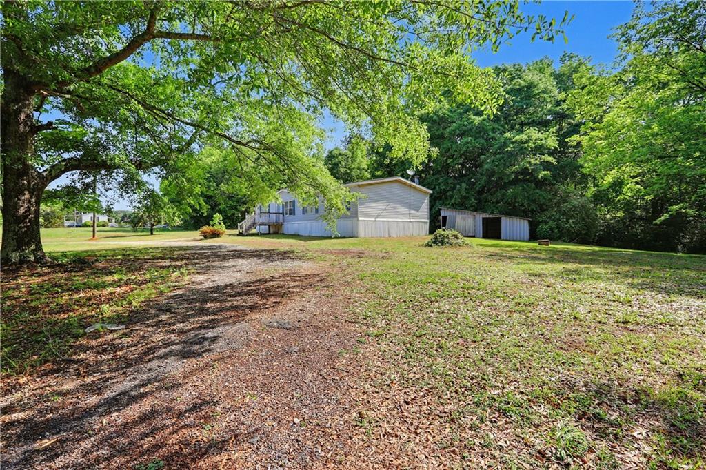 249 John Golden Road Temple, GA 30179 - Photo 5 of 45 a big yard with large trees