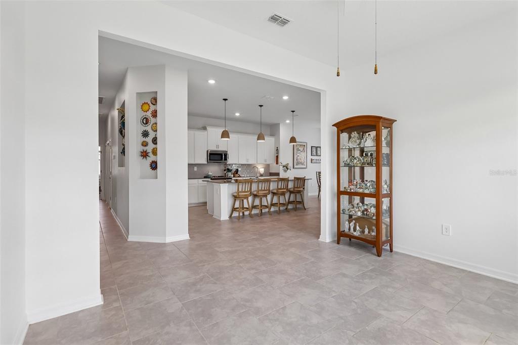 6049 Claystone Way Mount Dora, FL 32757 - Photo 19 of 55 a open kitchen with stainless steel appliances a refrigerator and a stove top oven