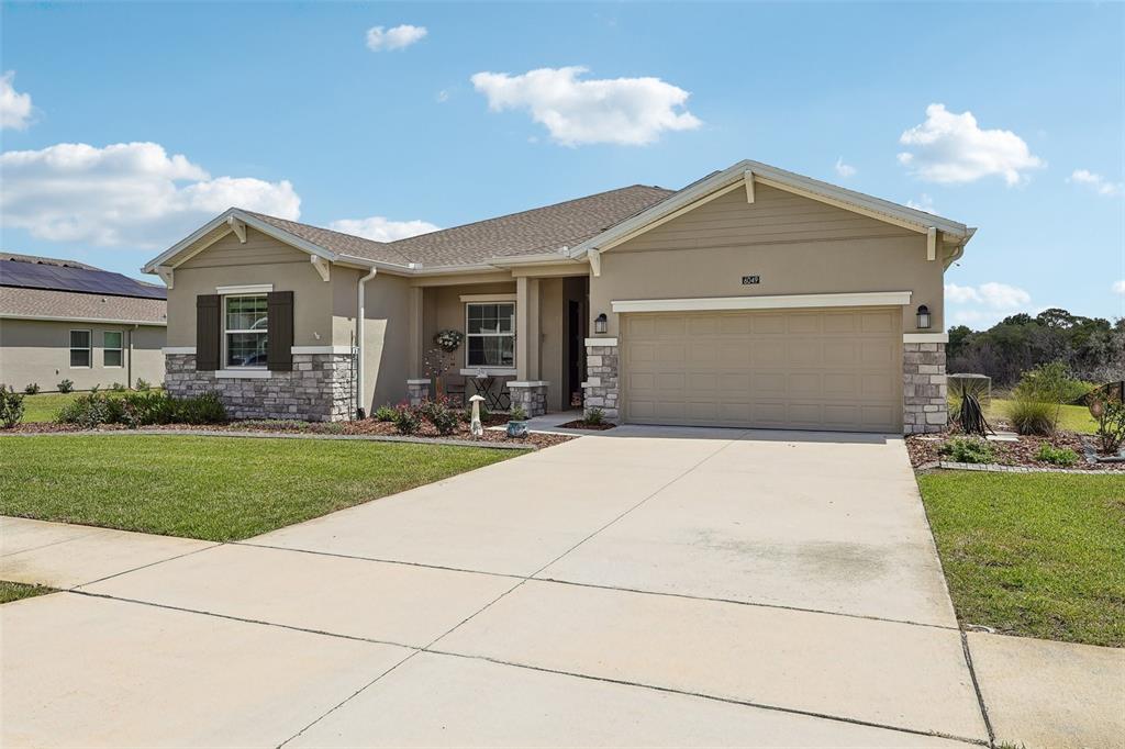 6049 Claystone Way Mount Dora, FL 32757 - Photo 2 of 55 a front view of house with yard and green space