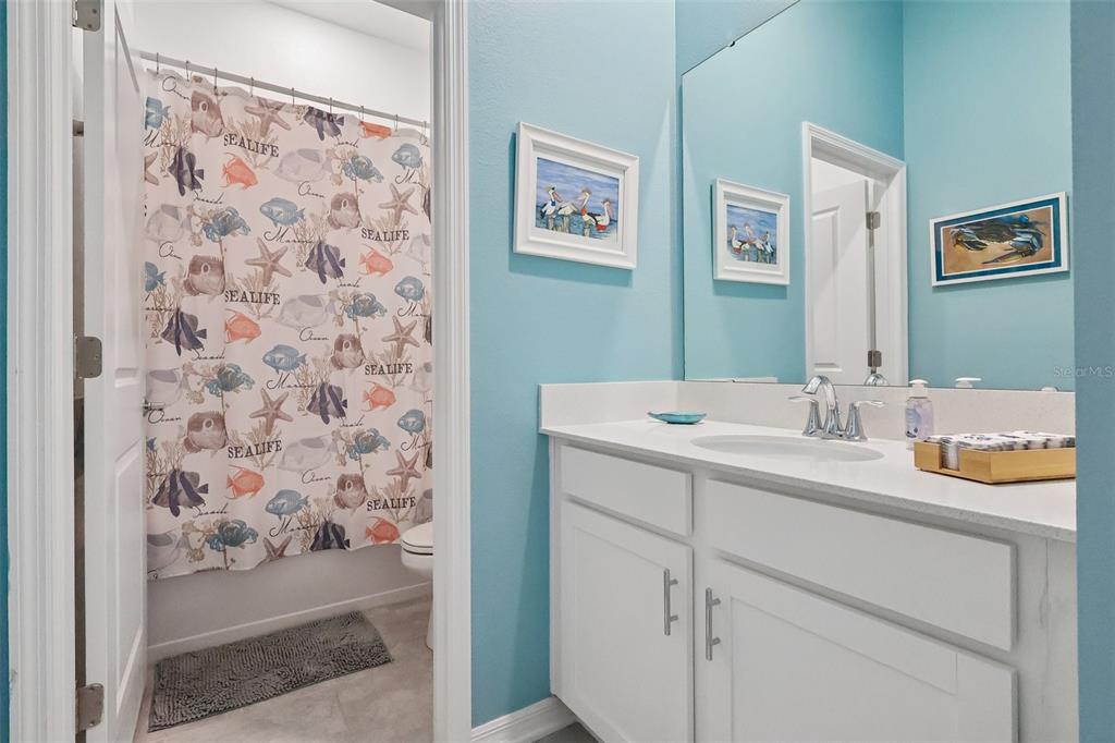 6049 Claystone Way Mount Dora, FL 32757 - Photo 21 of 55 a bathroom with a sink and a mirror