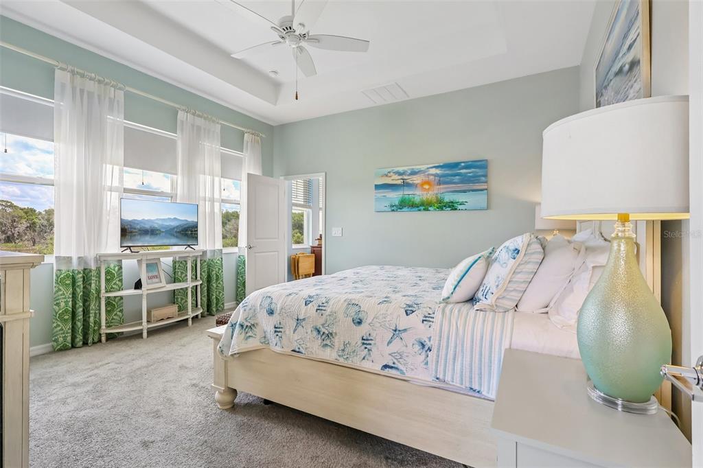6049 Claystone Way Mount Dora, FL 32757 - Photo 24 of 55 a bedroom with a bed a couch and large window