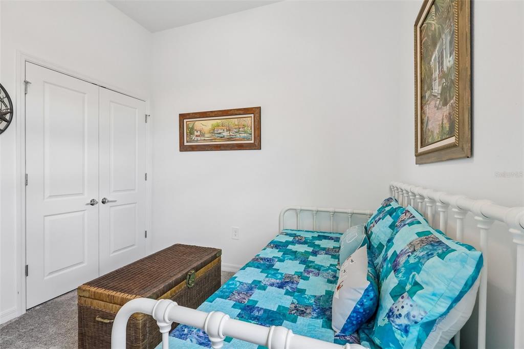 6049 Claystone Way Mount Dora, FL 32757 - Photo 30 of 55 a bed sitting in a bedroom next to a window
