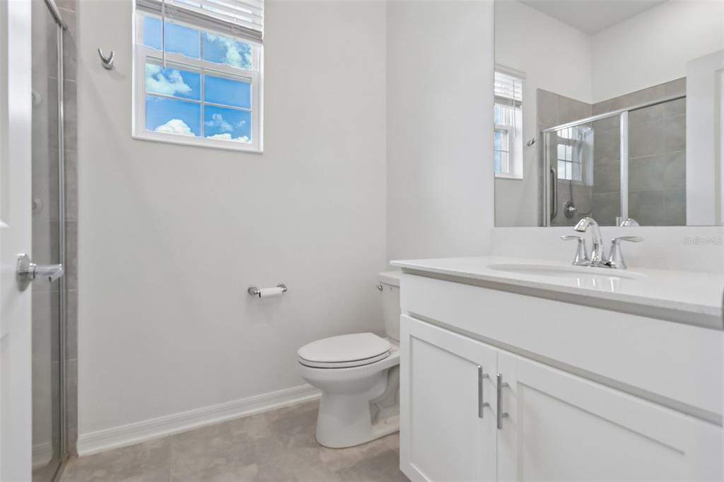 6049 Claystone Way Mount Dora, FL 32757 - Photo 35 of 55 a bathroom with a toilet sink and mirror