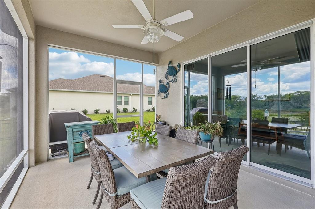 6049 Claystone Way Mount Dora, FL 32757 - Photo 36 of 55 a view of a dining room with furniture large windows and wooden floor