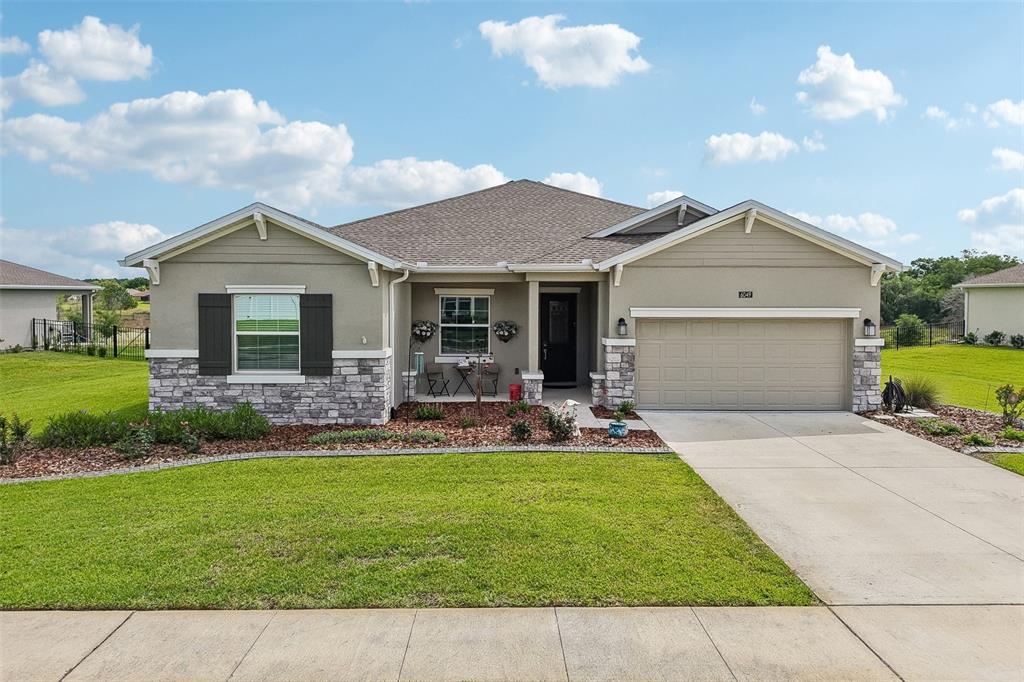 6049 Claystone Way Mount Dora, FL 32757 - Photo 41 of 55 a front view of a house with a yard and garage