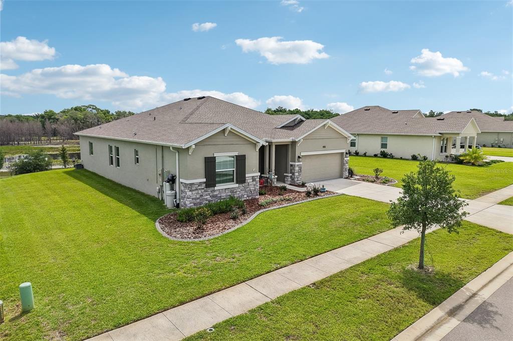 6049 Claystone Way Mount Dora, FL 32757 - Photo 43 of 55 a front view of a house with garden