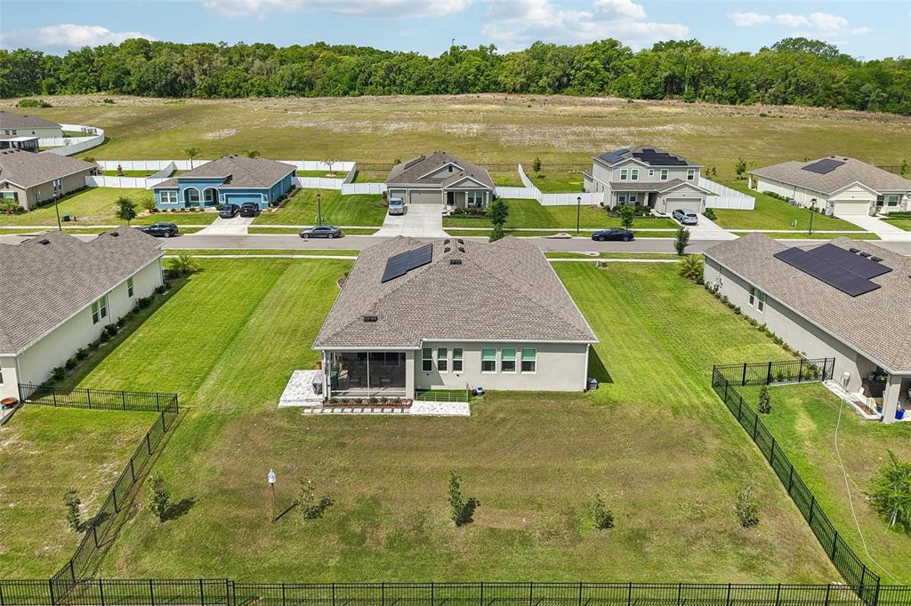 6049 Claystone Way Mount Dora, FL 32757 - Photo 47 of 55 a aerial view of a house with pool and a yard