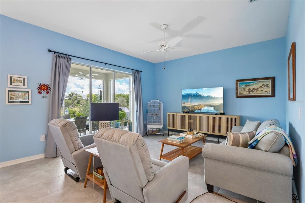 6049 Claystone Way Mount Dora, FL 32757 - Photo 8 of 55 a living room with furniture and a large window