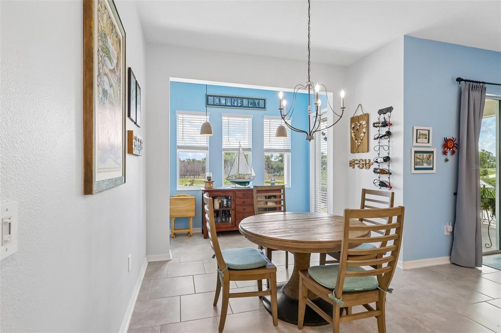 6049 Claystone Way Mount Dora, FL 32757 - Photo 10 of 55 a view of a dining room with furniture and chandelier