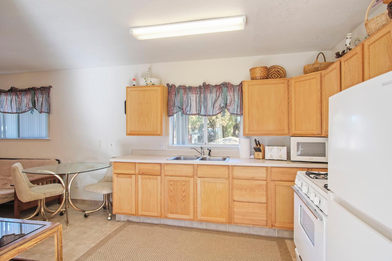 825 Wetherbee Avenue Manteca, CA 95337 - Photo 4 of 22 a bathroom with a sink double vanity and a mirror