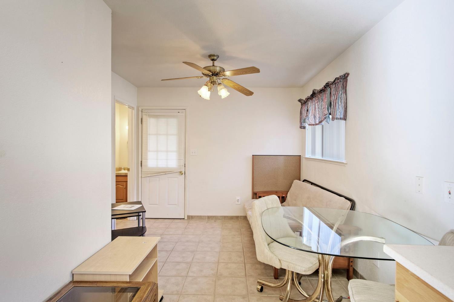 825 Wetherbee Avenue Manteca, CA 95337 - Photo 5 of 22 a living room with furniture and a chandelier