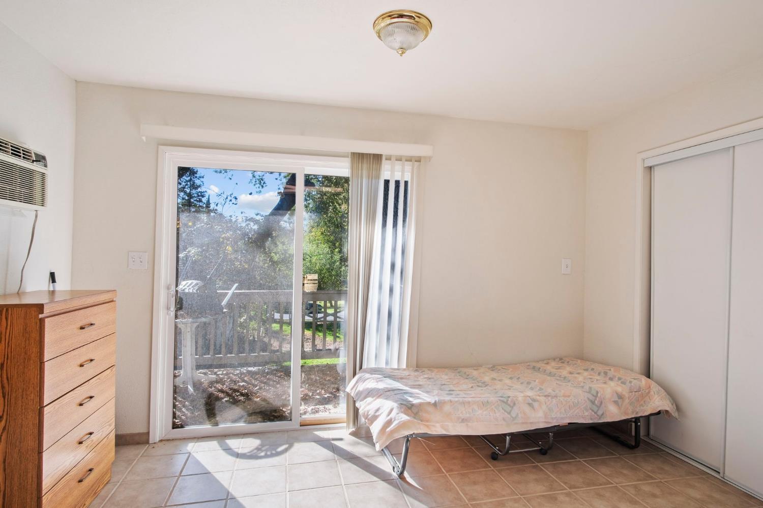 825 Wetherbee Avenue Manteca, CA 95337 - Photo 6 of 22 a bedroom with a bed and a window