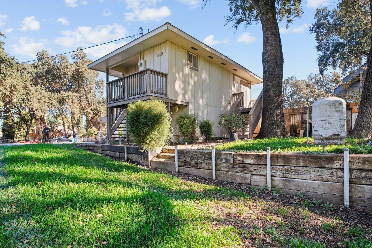 825 Wetherbee Avenue Manteca, CA 95337 - Photo 9 of 22 a view of a wooden fence with a bench in a yard