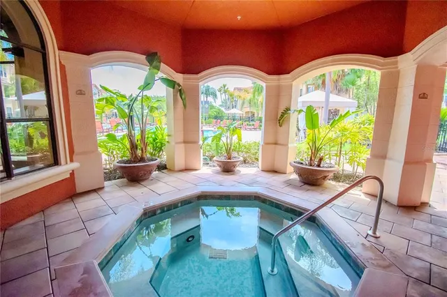 a living room with a floor to ceiling windows and pool table