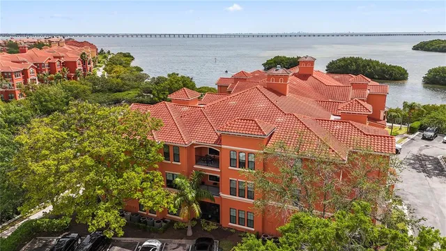 an aerial view of residential houses with outdoor space and a street view