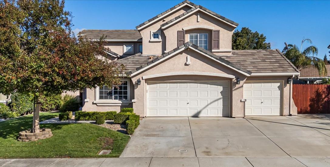 442 South Manley Road Ripon, CA 95366 - Photo 1 of 1 a front view of a house with a yard and garage