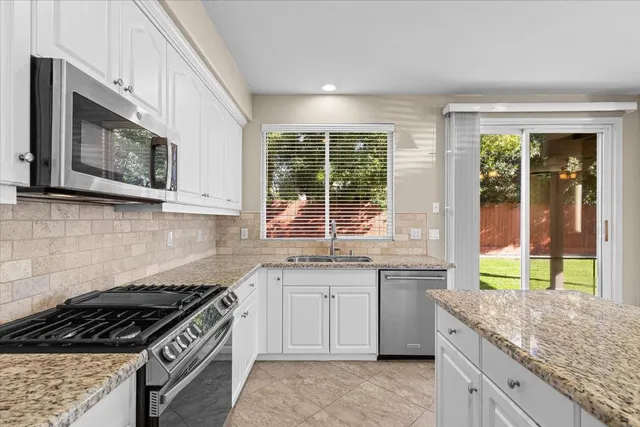 a living room with furniture potted plant and a fireplace