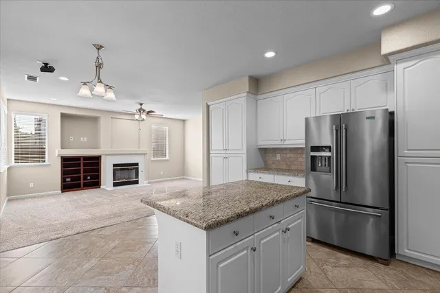 a view of a livingroom with a ceiling fan and window