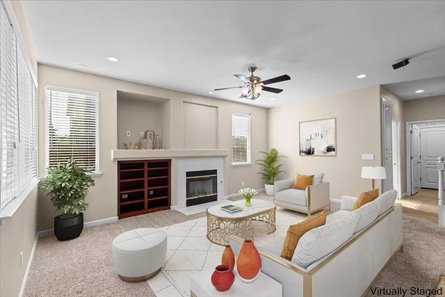 a living room with furniture kitchen view and a chandelier