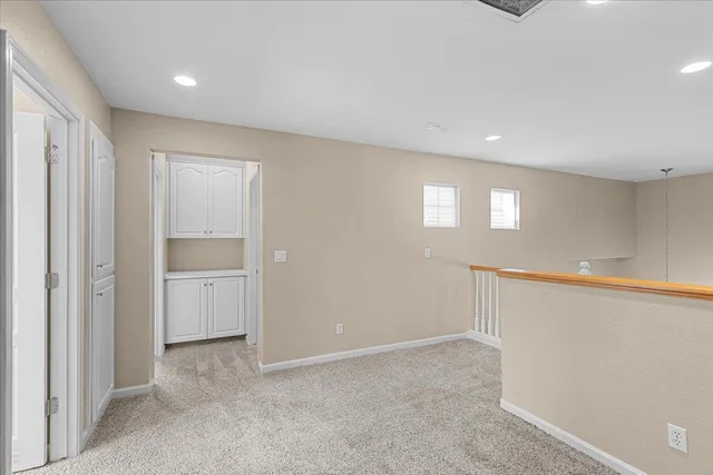 a balcony with wooden floor and fence