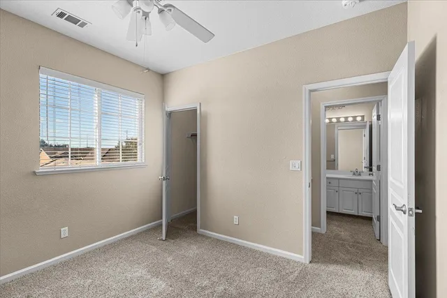 a spacious bathroom with a double vanity sink a large mirror and a bathtub