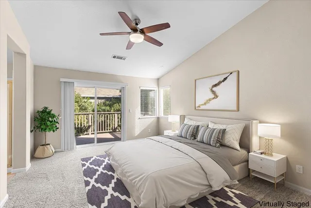 a view of backyard with large tree and wooden fence