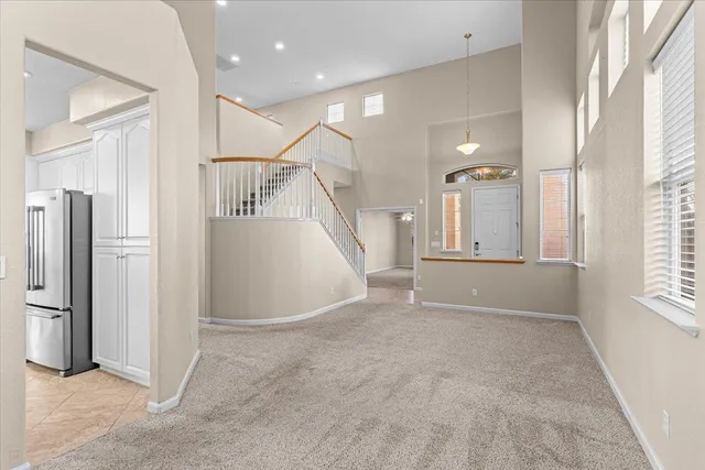 a large kitchen with a large window stainless steel appliances and white cabinets