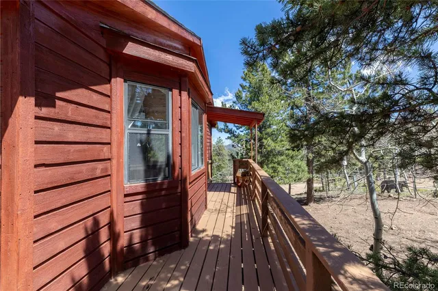 a view of balcony with wooden floor and barbeque oven