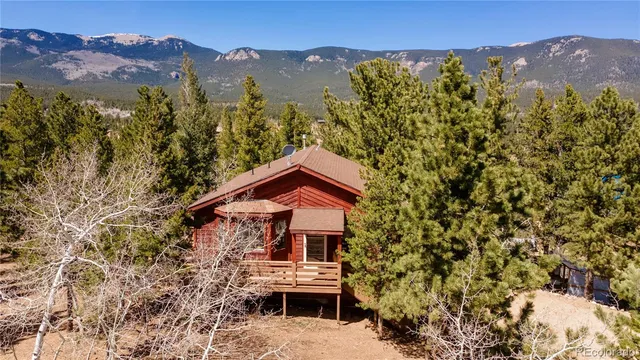 an aerial view of house with a mountain