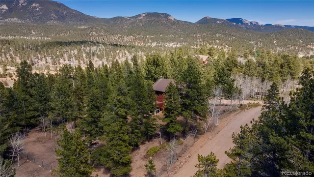 an aerial view of a house with a yard and lake view